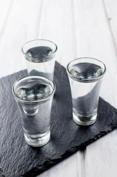 Vodka shots on white table Stock-Fotos