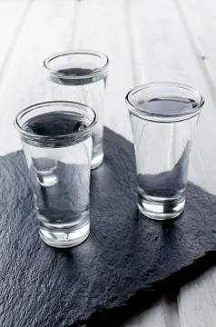 Vodka shots on white table Stockfoto's