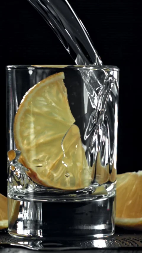 Vodka with a slice of lemon. Filmed on a high-speed camera at 1000 fps Stock Footage 335363147