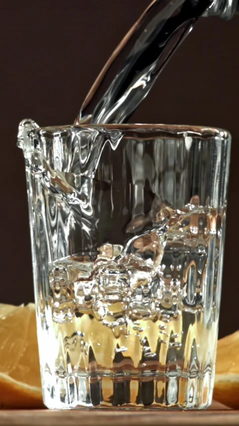 Vodka with a slice of lemon. Filmed on a high-speed camera at 1000 fps Stock Footage 335371199