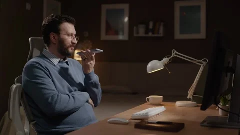 Voice message, freelancer at work concept. Male freelancer in home office uses Stock-Footage 337646006