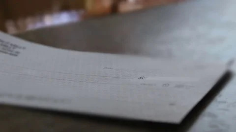 A Voided check with ominous lighting on a table Stock Footage 77626550