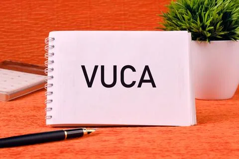 Volatility Uncertainty Complexity Ambiguity. VUCA text on a blank notepad pag Stockfoto's