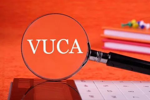 Volatility Uncertainty Complexity Ambiguity. VUCA text through a magnifying g Stock Photos