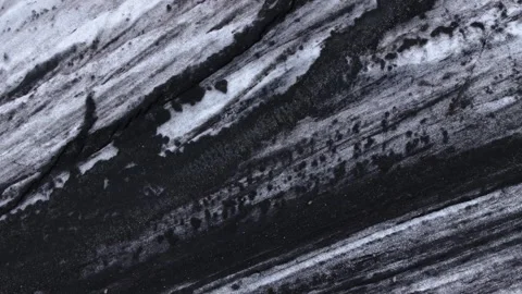 Volcanic ash on ice by Hoffelsjökull glacier in Iceland, aerial pan Stock Footage 342480526