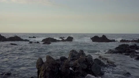 Volcanic black rocks washed by ocean waters in Puerto de la Cruz, Tenerife Stock Footage