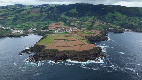 Volcanic cape with steep basalt cliffs and patchwork terraces Stock Footage 323710685