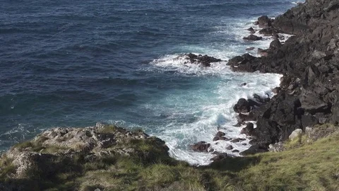 Volcanic coastline, waves breaking Stock Footage 83934128
