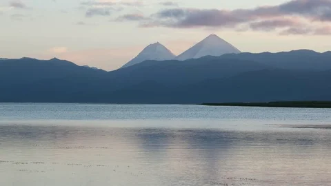 Volcanic cones behind lake Stock Footage 70388249