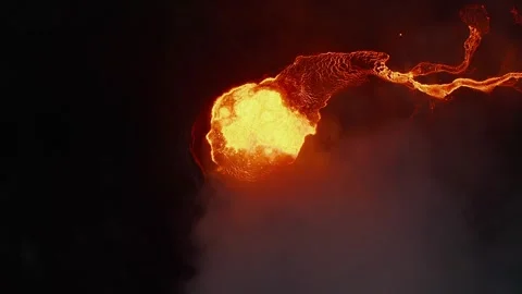 Volcanic Eruption Aerial View Featuring Molten Lava Flowing over Dark Terrain 库存影片 331044804