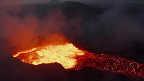 Volcanic Eruption Displaying Glowing Molten Lava Flowing from Mountain Crater 库存影片 331044428