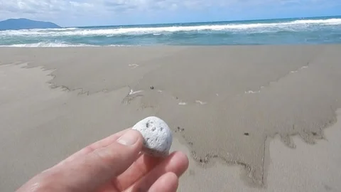 Volcanic floating pumice stone arrived on the beach brought by the sea 4732 Stock Footage 108467973