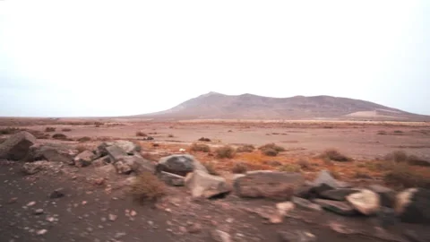 Volcanic island under cloudy sky Stock Footage 318800282