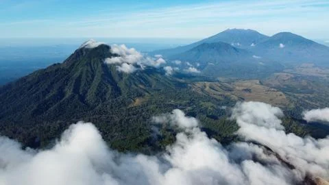 Volcanic landscape with clouds covering java island mountains Stockfoto's