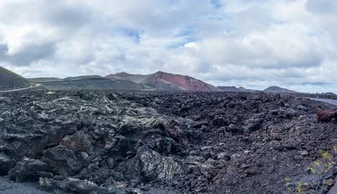 Volcanic Landscape Under Dramatic Cloudy Skies Stock Photos