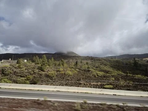 Volcanic landscape under dramatic cloudy sky Stock Photos