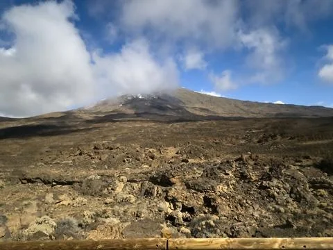 Volcanic mountain landscape under cloudy blue sky 스톡 사진