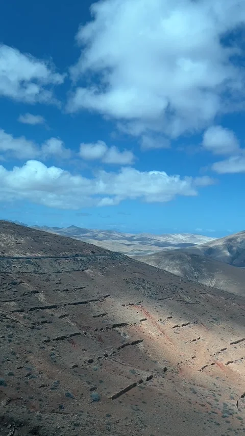 Volcanic mountains desert landscape cloud shadows pan Fuerteventura HD vertical Stock Footage 342028812