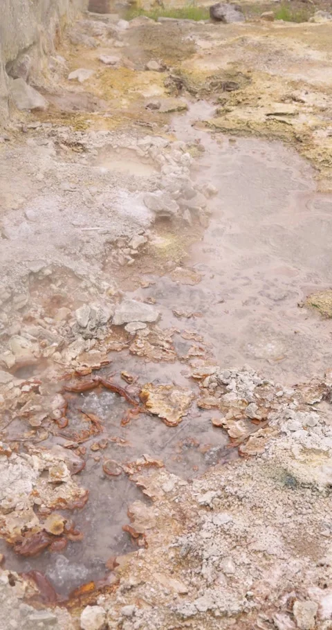 Volcanic pit with mud and boiling water with steam rising to the surface in.. Stock Footage 329618313