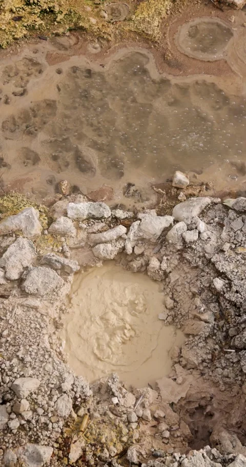 Volcanic pit with mud and boiling water with steam rising to the surface in.. Stock Footage 330101379