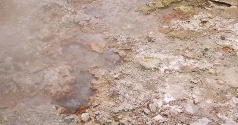 Volcanic pit with mud and boiling water with steam rising to the surface in.. Stock Footage 330414951