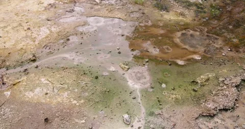 Volcanic pit with mud and boiling water with steam rising to the surface in.. Stock Footage 330415003