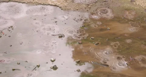 Volcanic pit with mud and boiling water with steam rising to the surface in.. Stock Footage 335027224