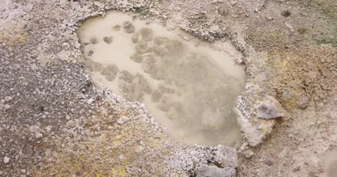 Volcanic pit with mud and boiling water with steam rising to the surface in.. Stock Footage 335027555