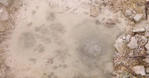Volcanic pit with mud and boiling water with steam rising to the surface in.. Stock Footage 335027695