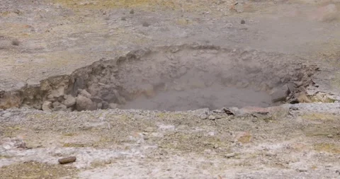 Volcanic pit with mud and boiling water with steam rising to the surface in.. Stock Footage 335028292