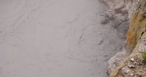 Volcanic pit with mud and boiling water with steam rising to the surface in.. Stock Footage 335028576