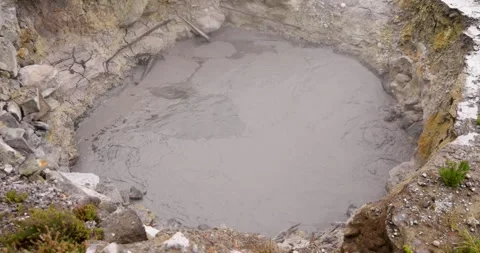 Volcanic pit with mud and boiling water with steam rising to the surface in.. Stock Footage 335028712