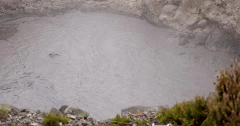 Volcanic pit with mud and boiling water with steam rising to the surface in.. Stock Footage 335028811
