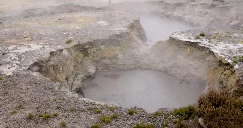 Volcanic pit with mud and boiling water with steam rising to the surface in.. Stock Footage 335029078