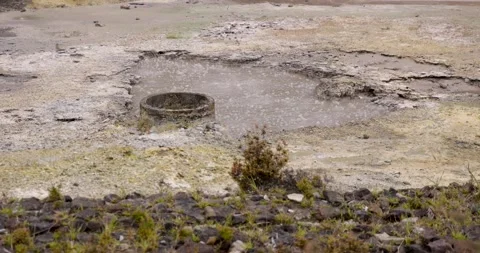 Volcanic pit with mud and boiling water with steam rising to the surface in.. Stock Footage 335029225