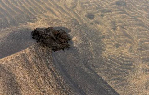 Volcanic Rock and Sand Patterns with Water Stock Photos
