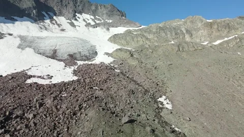 Volcanic Rock displaced below a pocket Glacier, Aerial View Stock Footage 289557475