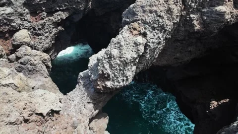 Volcanic rock formations and crashing waves at Los Hervideros, Lanzarote, Spain Stock Footage 346375967