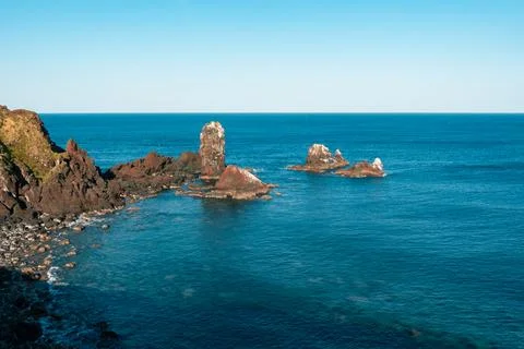 Volcanic rock formations in deep blue sea in Jeju island (South korea) Foto stock