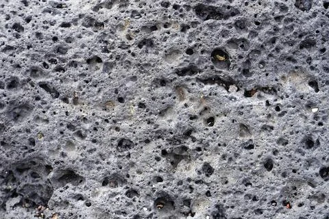 Volcanic rock surface texture showing porous basalt pattern Stock Photos