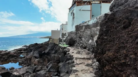 Volcanic rocks and weathered building walls, Punta Brava, Puerto de la Cruz Stock Footage 346472757