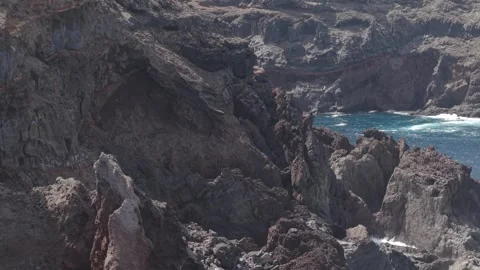 Volcanic rocks edging deep blue Atlantic waters along La Palmas dramatic Canary 스톡 동영상 308399547