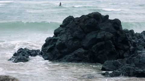 Volcanic rocks waves and kite surfer jeju island south korea Stock Footage 229424421