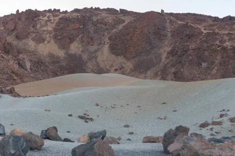 Volcanic sand of different colors, in a plain between mountain peaks at the t Stock Photos