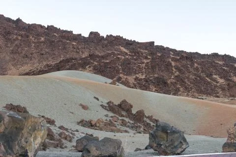 Volcanic sand of different colors, in a plain between mountain peaks at the t Stock Photos