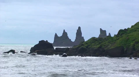 Volcanic seastack pinnacles from the beach Stock Footage 37586952