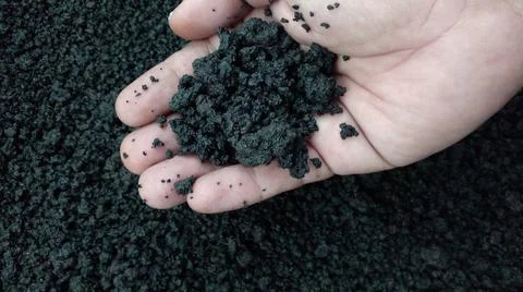 Volcanic soil in hands Stock Photos