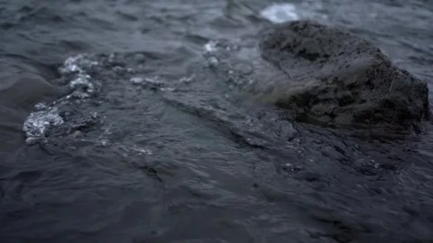 Volcanic stack smoothly soothed by the flow of glacier river Video stock 252340888