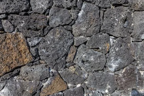 Volcanic stone wall texture background Stock Photos