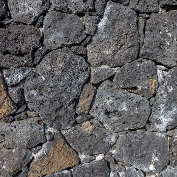 Volcanic stone wall texture background Stock Photos